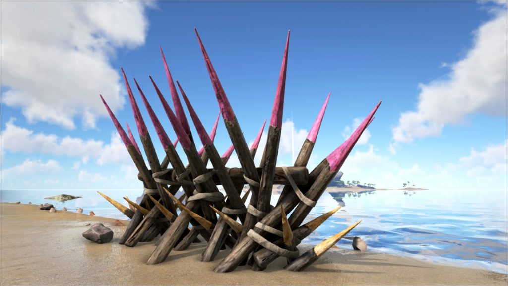 Wooden spikes on a beach made from mature trees. Large wooden defensive spikes on a beach.
